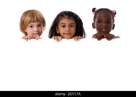 Group of multiracial kids portrait in studio with white board.Isolated Stock Photo