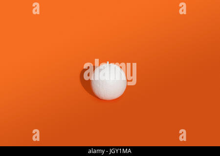 Orange painted white on orange background Stock Photo