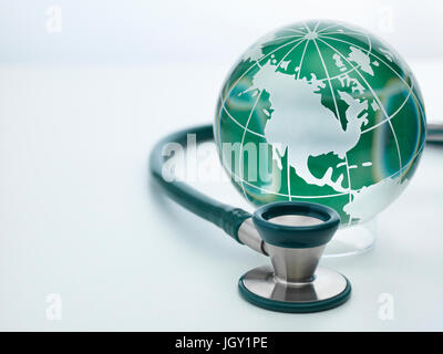 Acoustic stethoscope and globe Stock Photo