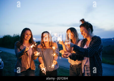 Friends playing with sparklers Stock Photo