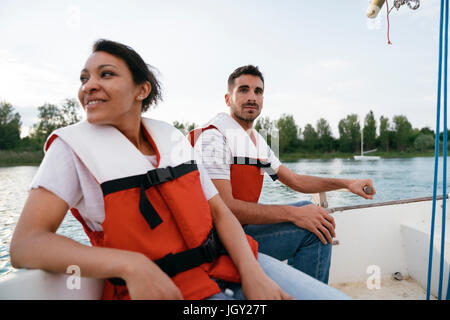 Man and woman on sailing boat on lake, close-up Stock Photo