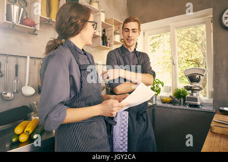 Chefs in kitchen chatting Stock Photo