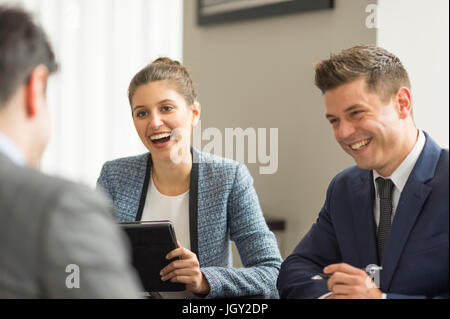 Businessmen and woman having office meeting Stock Photo