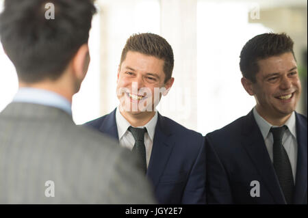 Over shoulder view of two businessmen having discussion in office Stock Photo