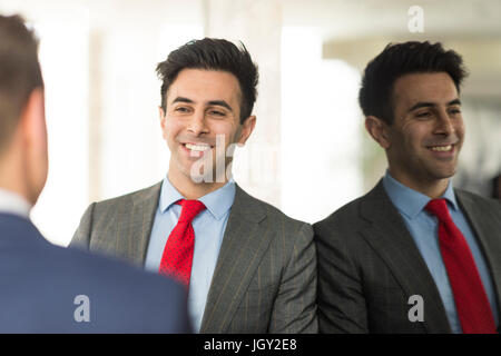 Over shoulder view of two businessmen having discussion in office Stock Photo