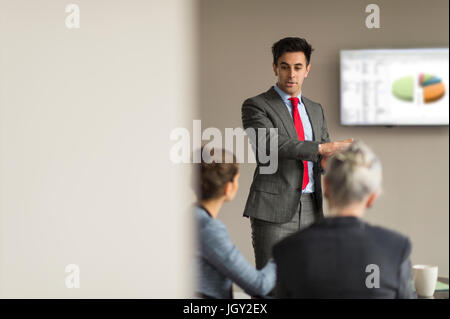 Over shoulder view of businessman making office presentation to colleagues Stock Photo