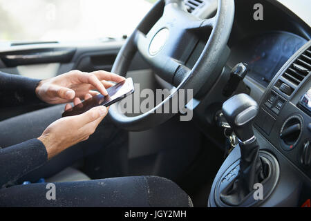 Man using smartphone in car Stock Photo