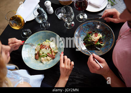 Overhead view of couple eating lunch at restaurant table Stock Photo