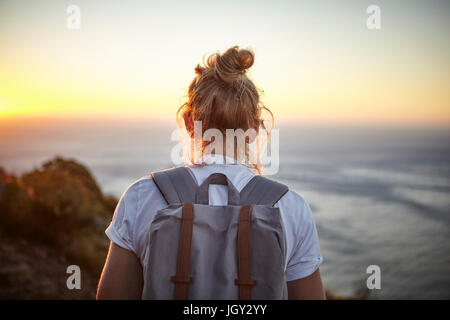Young woman hiking, rear view, Lions head Mountain, Western Cape, Cape Town, South Africa Stock Photo