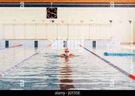 Senior man swimming in swimming pool Stock Photo