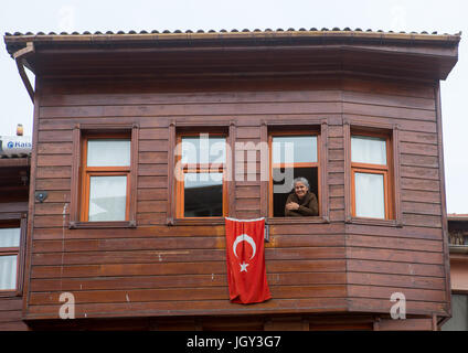 Smiling woman in her old wooden style house near the Bosphorus sea, Marmara Region, istanbul, Turkey Stock Photo