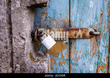 Combination rusty lock closes an old door Stock Photo