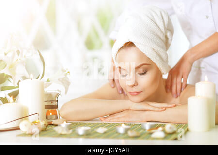 girl lying down on a massage bed Stock Photo