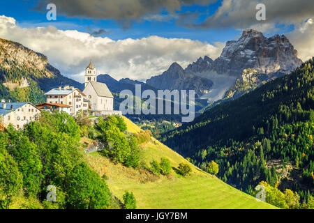Stunning alpine spring landscape with church on the Santa Lucia pass and Pelmo mountain group in background, Colle Santa Lucia, Dolomites, Italy, Euro Stock Photo
