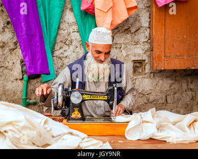 Leh, Ladakh, India, July 12, 2016: a tailor is working at his shop on a small street in Leh, India Stock Photo