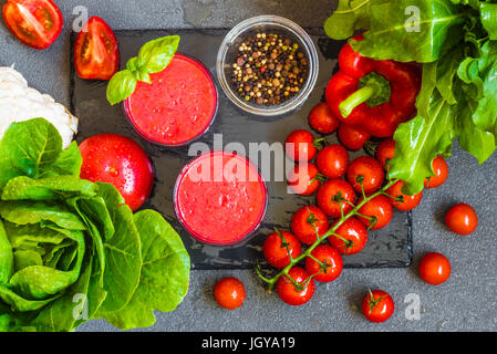 Fresh tomato detox smoothie in two glasses on a grey background. Stock Photo
