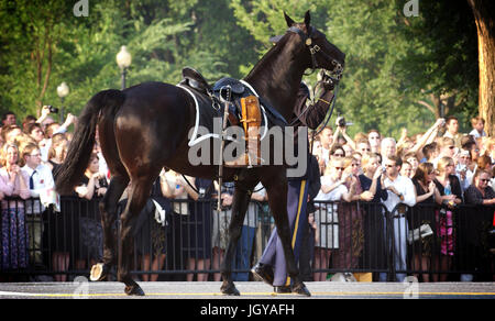 A riderless horse follows the caisson bearing former President Ronald Reagan's flag-draped casket during his funeral procession here June 9.  A pair of President Reagan's boots are reversed in the stirrups of the empty saddle symbolizing that he will never ride again.  He served as the military's commander-in-chief from 1981 to 1989. Stock Photo