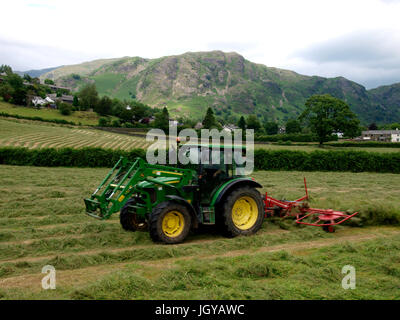 a farmer with a rake at the hay work a farmer at hay work Stock Photo ...