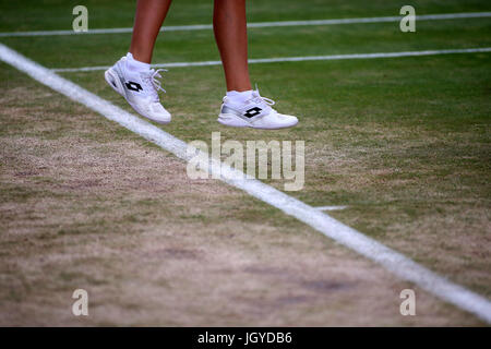 General view of the wear and tear to the grass on the baseline of court sixteen on day eight of the Wimbledon Championships at The All England Lawn Tennis and Croquet Club, Wimbledon. Stock Photo