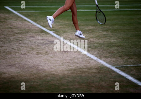 General view of the wear and tear to the grass on the baseline of court sixteen on day eight of the Wimbledon Championships at The All England Lawn tennis and Croquet Club, Wimbledon. Stock Photo