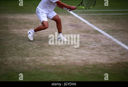 General view of the wear and tear to the grass on the baseline of court seventeen on day eight of the Wimbledon Championships at The All England Lawn Tennis and Croquet Club, Wimbledon. Stock Photo
