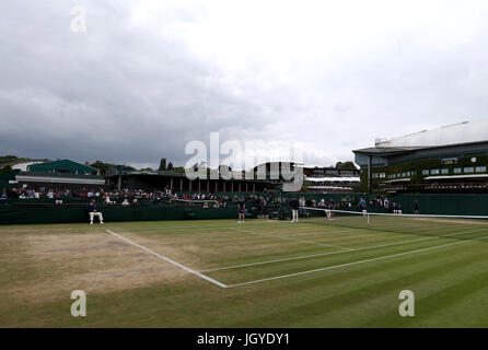 General view of the wear and tear to the grass on the baseline of court eleven on day eight of the Wimbledon Championships at The All England Lawn Tennis and Croquet Club, Wimbledon. Stock Photo