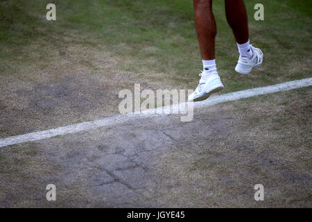 General view of the wear and tear to the grass on the baseline of court three on day eight of the Wimbledon Championships at The All England Lawn Tennis and Croquet Club, Wimbledon. Stock Photo