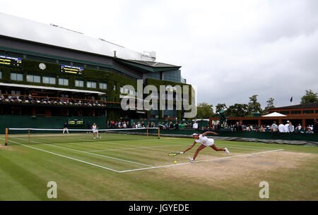 General view of the wear and tear to the grass on the baseline of court four as Whitney Osuigwe stretches for the ball on day eight of the Wimbledon Championships at The All England Lawn Tennis and Croquet Club, Wimbledon. Stock Photo
