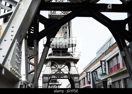 View through an industrial crane with MShed Museum and another crane in the background. Stock Photo