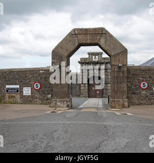 Granite wall and arch at the main entrance to HMP Dartmoor in Princetown Devon UK Stock Photo