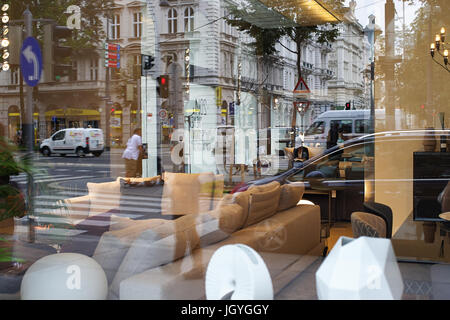 Streets of Vienna seen in reflections of window shop exposition. Stock Photo