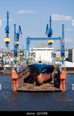 container ship in floating dock for maintenance Stock Photo