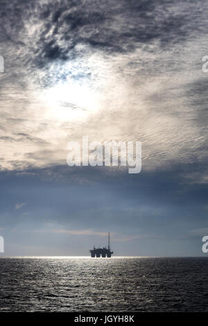 silhouette of an oil drilling rig in the North Sea Stock Photo