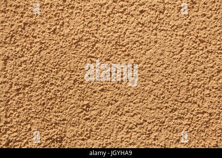 Orange painted stucco wall. Background texture. Stock Photo