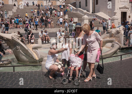 Rome, Italy - Family next to the fountain in Piazza di Spagna taking a selfie Stock Photo