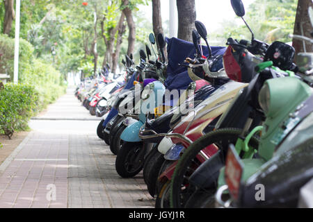 Scooter parking along the road in China Stock Photo