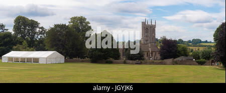 Newton St. Philip church and village green. Idyllic English village with ancient church of St. Philip and St. James and cricket pitch, Somerset, UK Stock Photo