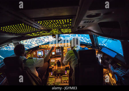 Two Pilots Departing out of Dallas Fort Worth Airport. Crew resource management taking place, both working together. In the background parts of Dallas Stock Photo