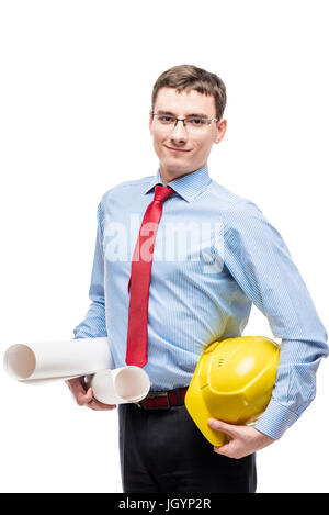 Man in blue shirt holds a helmet and blueprints on white background Stock Photo