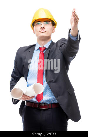 Architect in helmet showing his hand to the construction site of a house on a white background Stock Photo