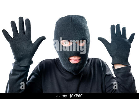 Robber in black protective clothing with hands up close-up portrait Stock Photo