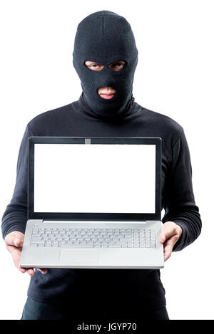 Hacker in a mask with a laptop, space for writing on the laptop's screen Stock Photo