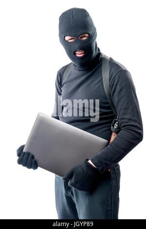 Thief in a balaclava with a laptop on a white background Stock Photo