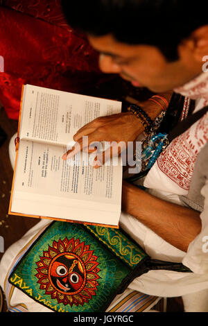 Gita Jayanti celebration in an ISKCON temple. Devotee reading the Bhagavad Gita. Sarcelles. France. Stock Photo