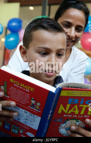 10-year-old boy reading with his mother. France. Stock Photo