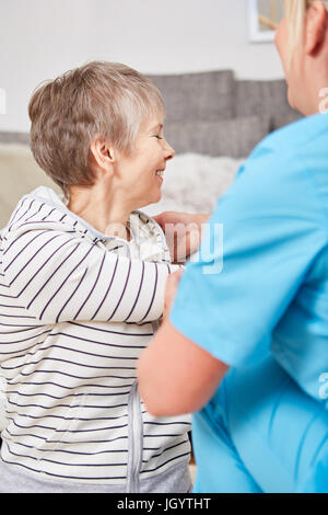 Senior woman in physiotherapy session with rehab nurse Stock Photo