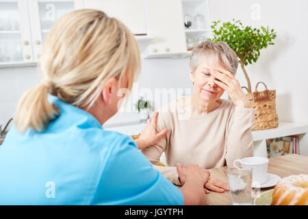 Nursing service at home for senior woman with dementia Stock Photo