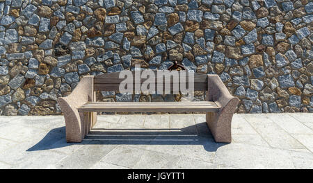 bench on stone wall Stock Photo