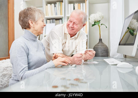 Senior couple of retirees  doing accounting at home Stock Photo