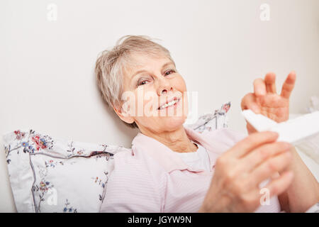 Senior woman holding pill box with medication Stock Photo